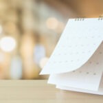 Desk Calendar On Table With Blurred Bokeh Background Appointment