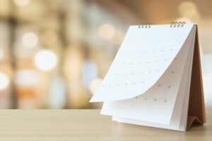 Desk Calendar On Table With Blurred Bokeh Background Appointment